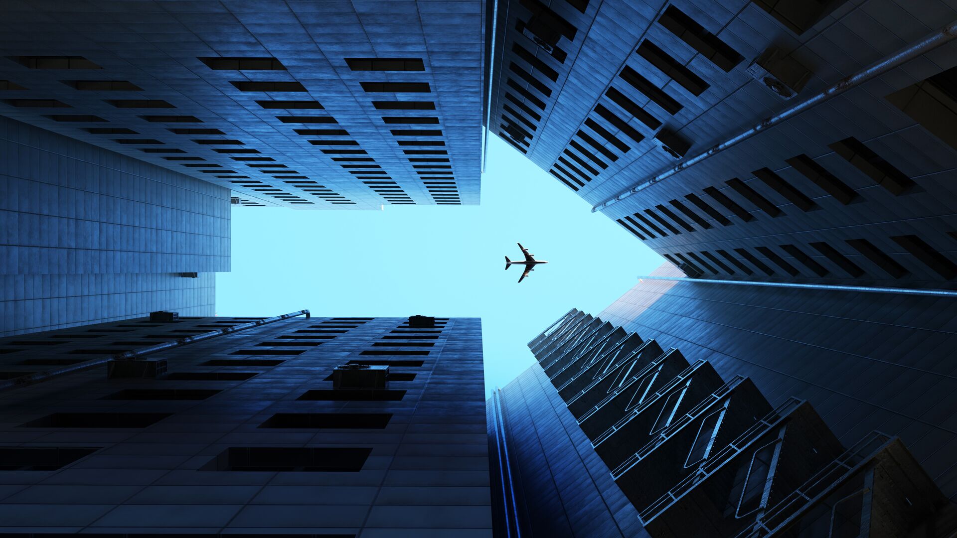 SAF, Sustainable Aviation Fuel concept as United is leading the way on ESG and sustainable aviation the image is of a plane flying over buildings. the view of the plane over the buildings in the sky, clearly appears as an arrow. Dramatic blue tone.
