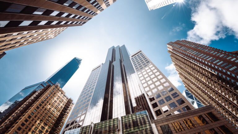 Image of tall buildings in NY's Financial Sector, representing Prime Brokerage and Moving on Up with the help of your broker.