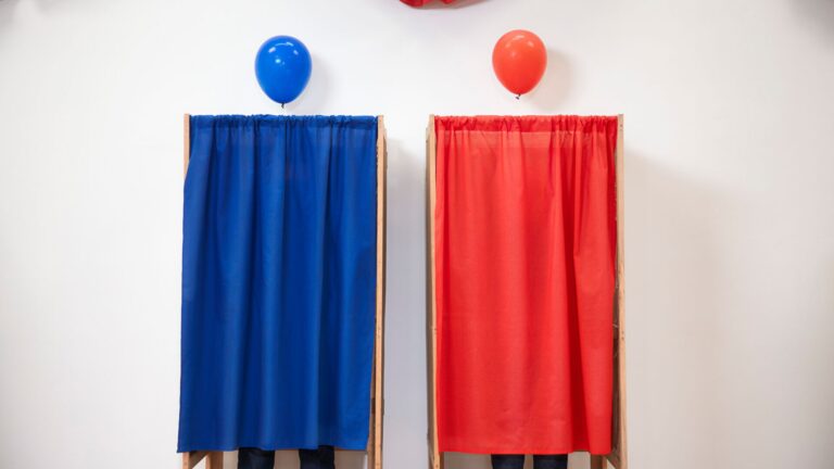 Two election booths, red & white, representing the upcoming Mid-Term elections in the U.S.