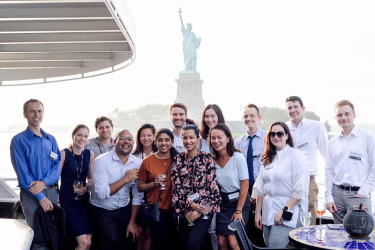 Group of people posing in front of the Statue of Liberty