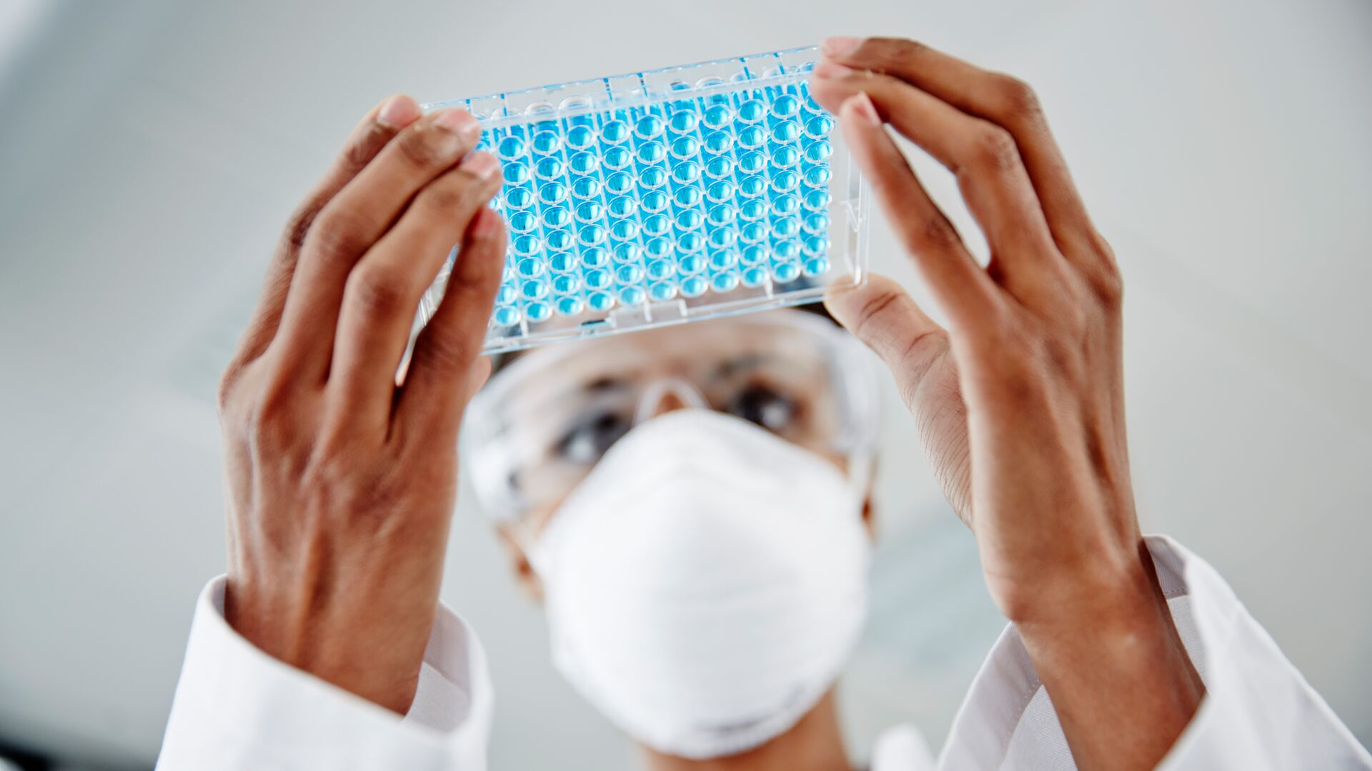 Woman examining biotechnology laboratory samples