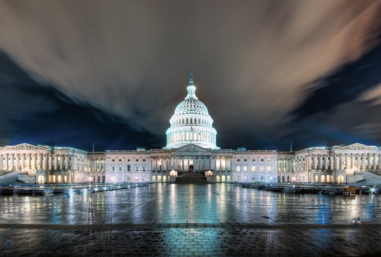 A photo of the U.S. Capitol building at night.